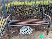 Front view of metal bench and umbrella stand under seat