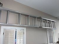 Side view of the full ladder showing aluminum construction and rung spacing.