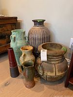 All six ceramic items grouped together on floor