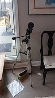 Full view of Bushnell refractor telescope mounted on aluminum tripod