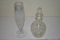 Crystal decanter and crystal vase side by side showing overall design and shape.