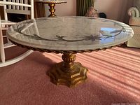 Full side view showing the marble top with floral inlay and ornate gold painted pedestal base.