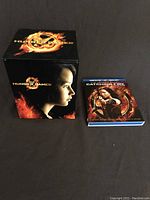 Decorative box and Catching Fire Blu-Ray case side by side on black background