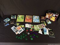 Full spread of decks, assorted markers, tokens, and dice alongside small stacks of cards and coin tokens.