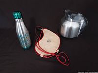 Set of stainless steel water bottle, IKEA thermos, and beige insulated carrying cover.
