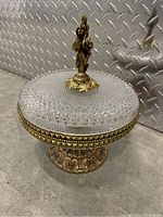 Full view of the glass serving dish on brass base with decorative handle