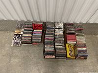 Photo of boxed collection of various CDs including Bob Dylan items and other artists, arranged on the floor.