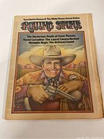 Front cover of the Rolling Stone Magazine showing illustrated man with pistol in desert scene and headings about articles inside.