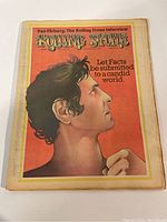 Front cover of Rolling Stone magazine featuring stylized side profile of a man on red background with the text 'Let Facts be submitted to a candid world.'