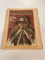 Front cover of the 1974 Rolling Stone magazine featuring a soldier in helmet with peace sign and crossed knives graphic.