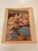 Front cover of the 1974 Rolling Stone magazine showing a close-up photo of a man holding a baby with various music article headlines.