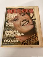 Front cover of the Rolling Stone magazine featuring Bonnie Raitt with title and article highlights.