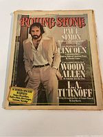 Front cover photo featuring Paul Simon standing with hands in pockets, beige suit, white shirt, large Rolling Stone title in red.
