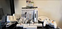 Overview: Nintendo Wii console, controllers, and accessories arranged on table