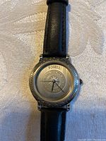 Close-up of Fossil watch face and strap on fabric surface.