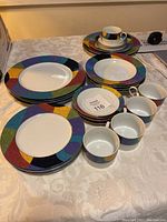 Full set of colorful Mikasa California plates, cups, saucers arranged on table showing multiple pieces in the set