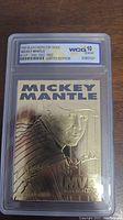 Front view of the 1996 Bleachers 23kt Gold Mickey Mantle baseball card in its WCG graded case, showing a gold embossed image of Mickey Mantle with MVP years and limited edition text.