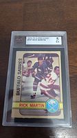 Front view of the graded 1972-73 Rick Martin rookie card by KSA with a grade of 5 in a clear plastic holder.
