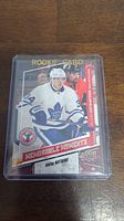 Front of Auston Matthews rookie card showing player's image and 'Memorable Moments' text.