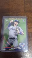 Front of Bo Bichette rookie baseball card in plastic case showing full color player image and team logos.
