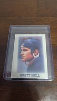 Front view of Brett Hull rookie hockey card in protective case showing player's image and name.