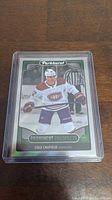 Front of Cole Caufield rookie hockey card showing action image and Parkhurst branding.