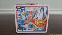 Front view of the G.I. Joe metal lunchbox showing detailed artwork with soldiers and patriotic symbols.