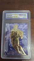Front side of the 1996-97 Skybox EX2000 Kobe Bryant rookie card featuring 23KT gold plating, with WCG 10 Gem MT grading visible on the label in a clear plastic slab.