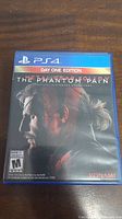 Front cover of the Metal Gear Solid V The Phantom Pain PS4 Day One Edition game case showing game art and relevant labeling.