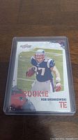 Front view of Rob Gronkowski rookie trading card showing the player in Patriots uniform with 'ROOKIE' text.