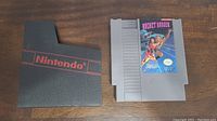 Front of Rocket Ranger NES cartridge showing the colorful label and original black Nintendo sleeve with red branding