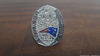 Front view of the Tom Brady 6th Replica Super Bowl Ring showing rhinestone-encrusted face and Patriots logo