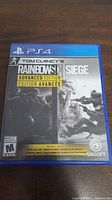 Front cover of PS4 game case for Tom Clancy's Rainbow Six Siege Advanced Edition showing cover art and title.