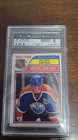 Front view of graded Wayne Gretzky hockey card 1984-1985 Scoring Leaders by SMA with grade 4 visible