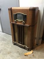 Front view of vintage Zenith wooden cabinet radio showing full cabinet height and base