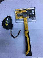 Claw hammer and tape measure from Work Zone brand, hammer in original packaging