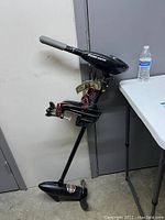 Full side view of Minnkota trolling motor mounted on a stand next to table