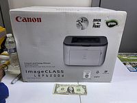 Box of Canon imageCLASS LBP6200d black and white desktop laser printer, showing original packaging, branding, model info, and specifications.