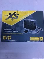 Packaging of the AutoXS Portable Tire Inflator showing 12V and 250 PSI capacity.