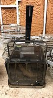 Front and side view of Pro Point PH-960 wall or ceiling mount heater with metal grill, mounting bracket, and control knob visible.