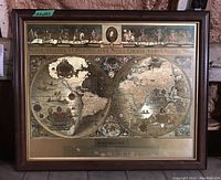 Full frontal photo of the framed Blaeu wall map reproduction showing the two hemispheres and ornate decoration.
