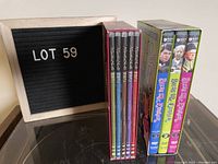 Two boxed DVD sets including Agatha Christie's Marple and Bless Me Father, showing spines and packaging.