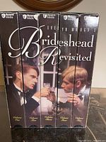 Side view of four VHS tapes in black boxed packaging with the title 'Brideshead Revisited' spelled across the spines. Each tape is labeled Volume One through Four.