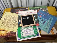 Seven assorted Christmas music LP vinyl record albums laid out on a yellow surface, showing covers from Andy Williams, Nana Mouskouri, and other artists.