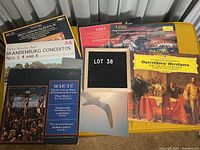 Photo of classical music LP album covers including Bach Cantatas, Brandenburg Concertos, Schutz, Liszt, Beethoven Symphony No. 9, and Brahms Overtures.