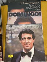 Close-up of two Placido Domingo albums: 'Domingo!' and 'Greatest Hits' with his portrait on covers.