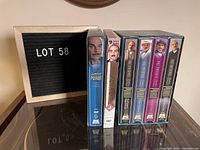 Photo showing the entire lot of Poirot boxed sets, including the DVD and VHS sets with cover art featuring David Suchet as Poirot.