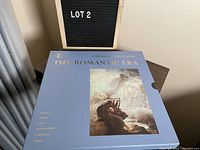 Boxed set in blue slipcase with gold text titled 'Concerts of Great Music - The Romantic Era' and artwork depicting a lyre player amid clouds.
