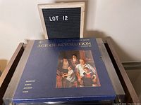 Boxed set front cover showing artwork of classical musicians with blue and gold color scheme, titled 'Age of Revolution'