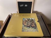 Front view of the gold colored box set titled 'Slavic Traditions' featuring image of Slavic musicians in traditional dress and lot number board.
